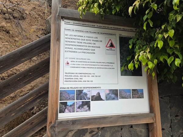 Cartel informativo en el sendero del Barranco Ruiz que advierte del peligro de desprendimientos, con fotos del recorrido y números de emergencia.